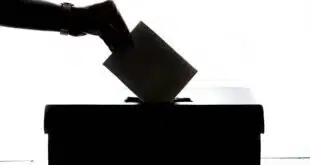 person dropping paper on box