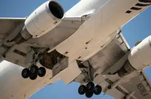 close up of airplane undercarriage in flight