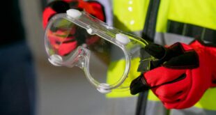 close up photo of person holding safety glasses